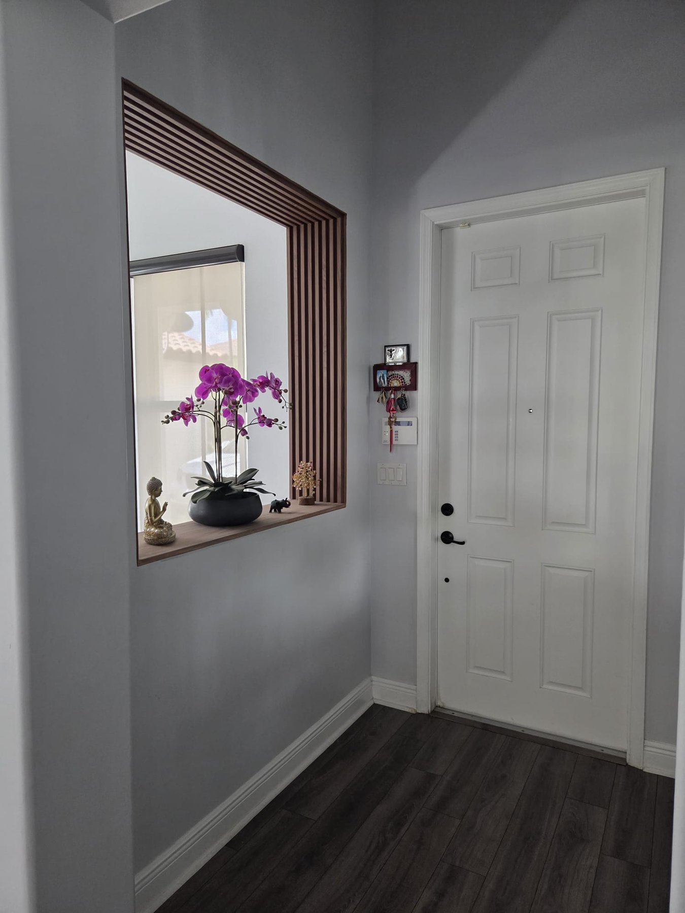 Completed entrance opening framed with warm wood slats