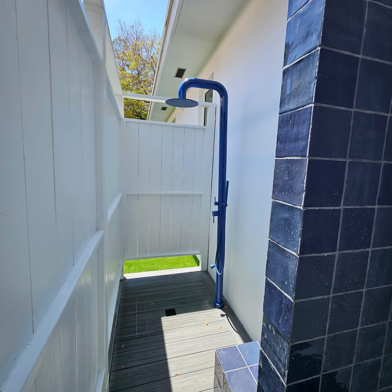 Private outdoor shower with rainfall fixture