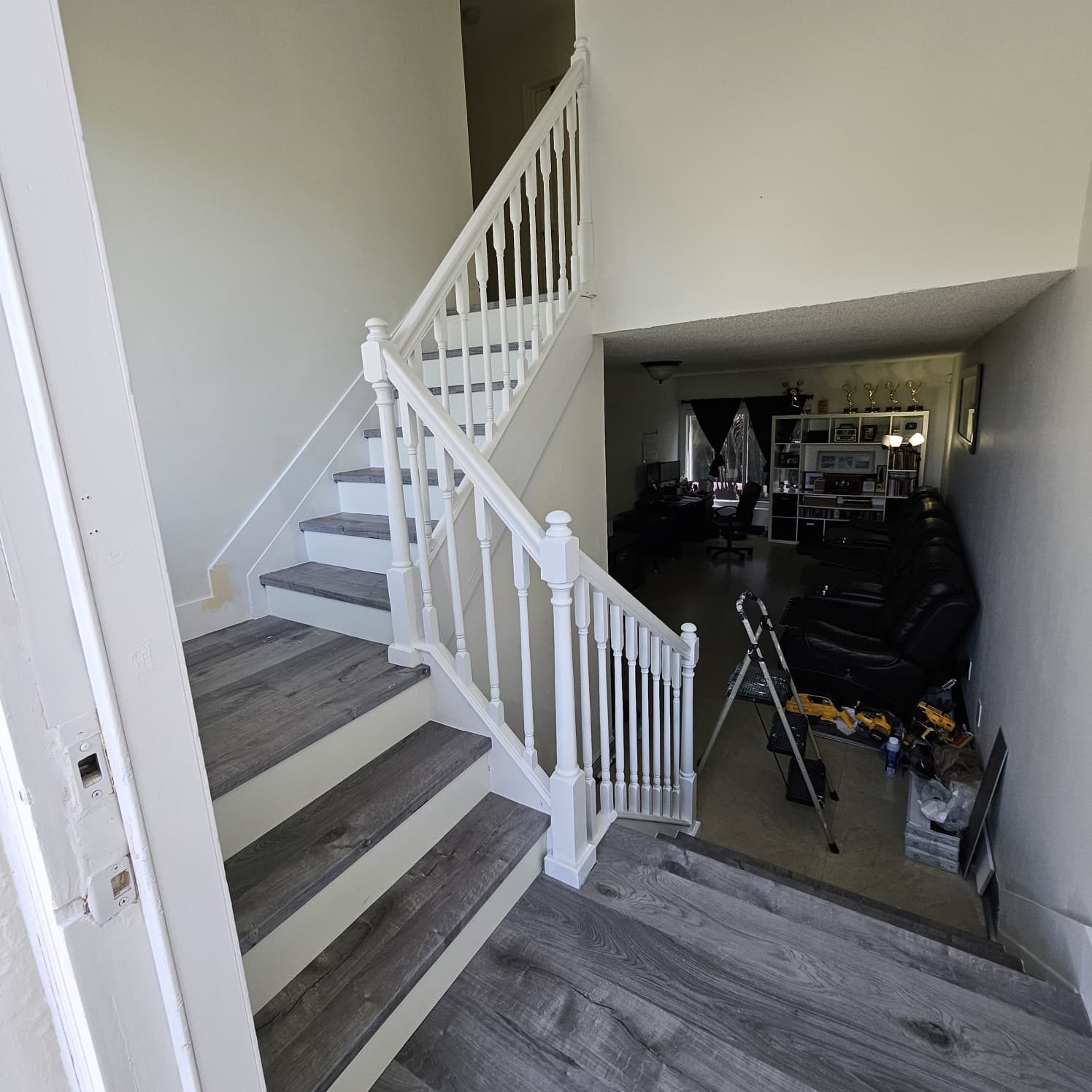 Staircase after the new surfaces and white railing were installed