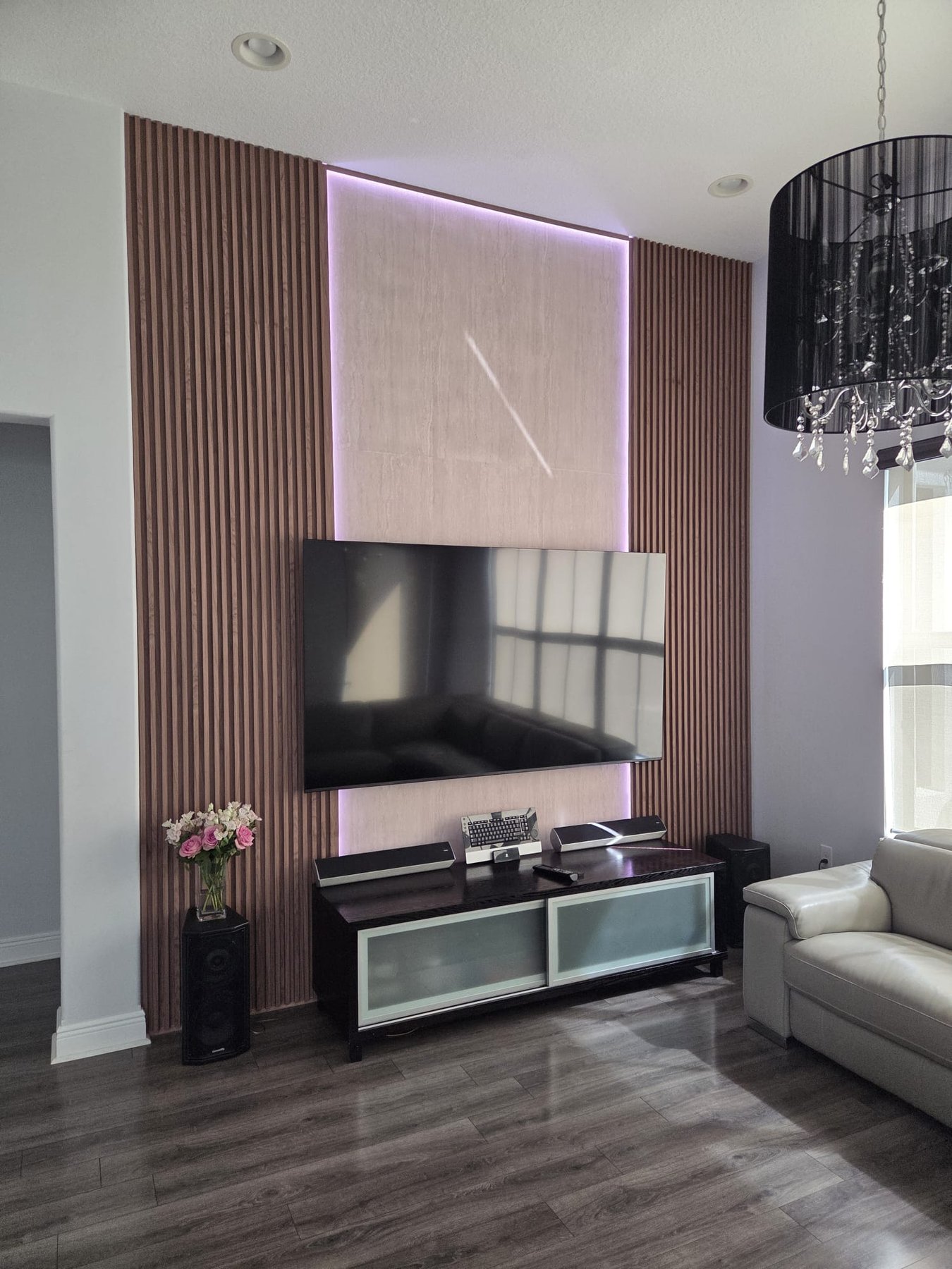 Completed television feature wall with wood slats and concealed LED lighting
